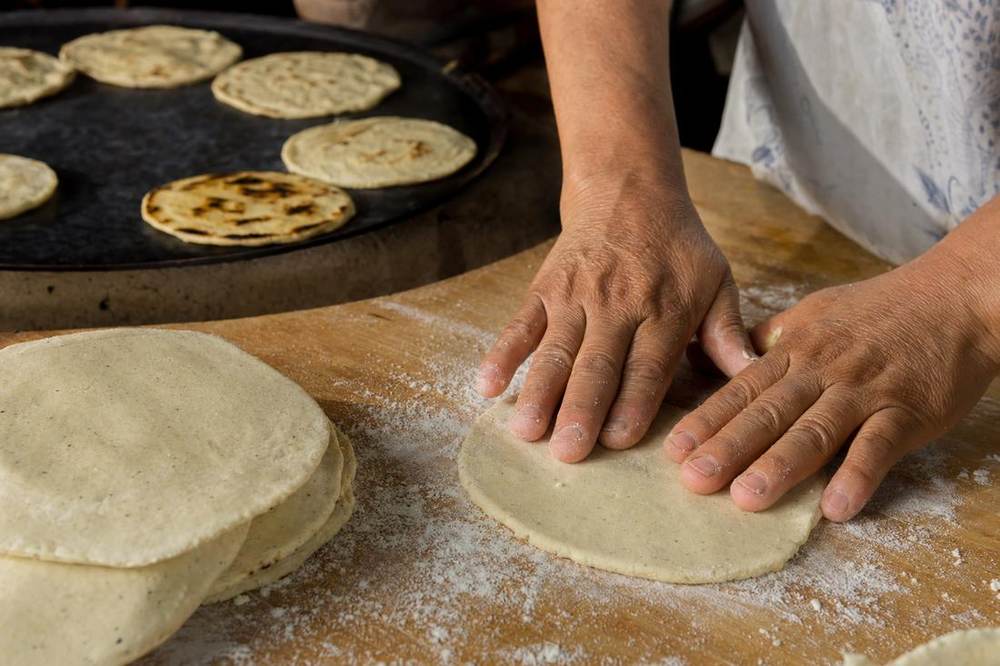 Fresh tortillas being pressed.